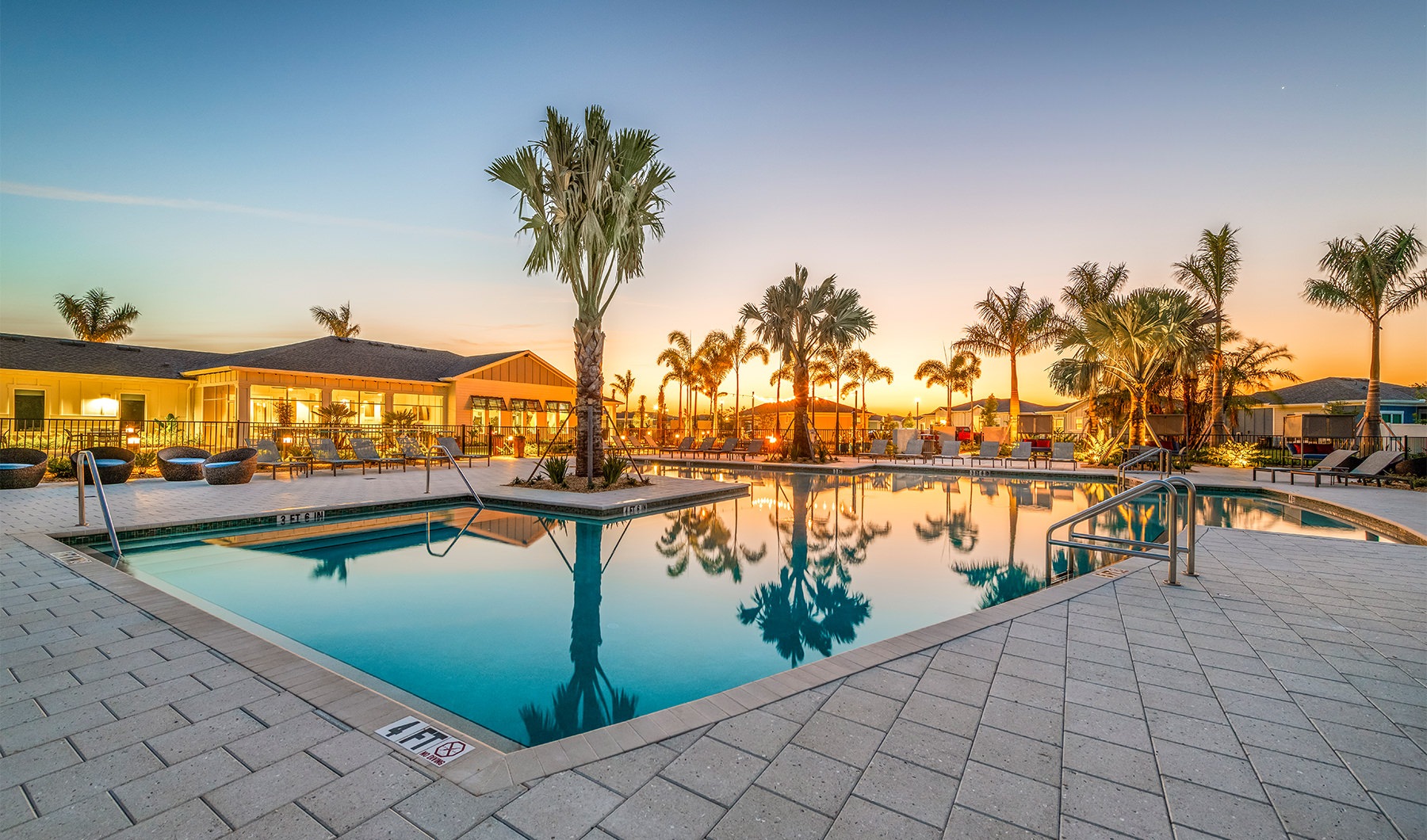 pool with trees and lounge chairs